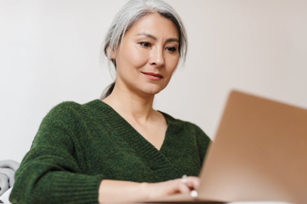 MED-mature-asian-woman-working-at-laptop-600px